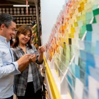 loving couple at hardware store choosing a color to paint their house - home decoration stock pictures, royalty-free photos & images