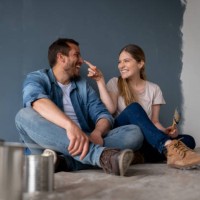 loving couple having fun painting their house and taking a break - home decoration stock pictures, royalty-free photos & images
