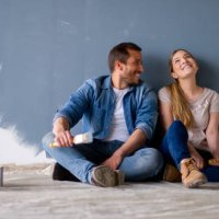loving couple having fun renovating their house and painting the walls - home decoration stock pictures, royalty-free photos & images