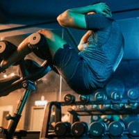 low angle view asian indian macho male athlete sit -ups workout at gym at night with weight bench - home decoration stock pictures, royalty-free photos & images