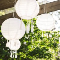 low angle view of white lanterns hanging from pergola at patio - garden decoration stock pictures, royalty-free photos & images