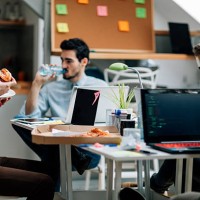 lunch time in the office. - junk food stockfoto's en -beelden