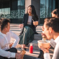 lunchtime relaxation with asian businesspeople outdoors - junk food stock pictures, royalty-free photos & images