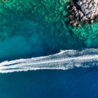 luxury speed boat floating in open sea at summer, yacht sailing in sea at hot summer day, seashore of mediterranean sea at summer, cruise speed boat floating in sea along rocky mountain coastline of mediterranean sea - travel