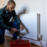 maintaining a radiator - home decoration stockfoto's en -beelden