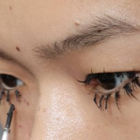 Make up artist does the final touch is seen backstage at the Fiorucci fashion show during the Milan Womenswear Spring/Summer 2025 on September 17,...