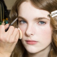 Makeup artist applies makeup to a model in backstage at the Max Mara fashion show during the Milan Fashion Week - Womenswear Fall/Winter 2025/2026 on...