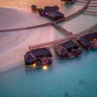 maldives island resort in sunset with view over horizon drone view - travel stock pictures, royalty-free photos & images