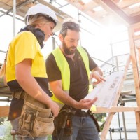 male and female construction workers discuss the building plans inside the building site - home decoration stock pictures, royalty-free photos & images