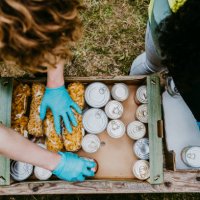 male and female friends arranging food in cardboard boxes - food stock pictures, royalty-free photos & images