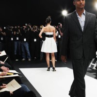 male and female models on catwalk, group of photographers in distance - fashion stock-fotos und bilder