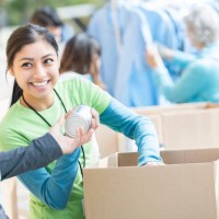 male and female volunteers sort donations during food drive - food stock pictures, royalty-free photos & images