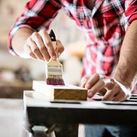 male carpenter varnishing board close up - home decoration stock pictures, royalty-free photos & images