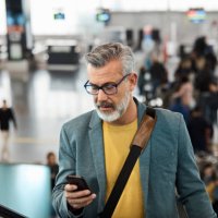 male commuter using smart phone on escalator - travel stock pictures, royalty-free photos & images