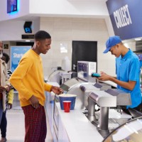 male customer paying at concession stand - junk food stock pictures, royalty-free photos & images