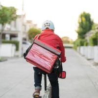 male delivery guy on bicycle with backpack in the city. - food stock pictures, royalty-free photos & images