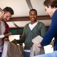 male friendship - having lunch at home together - junk food stock pictures, royalty-free photos & images