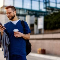 male nurse on the smartphone on the way to work - junk food stock pictures, royalty-free photos & images