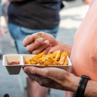 male person holding a fries tray - junk food stock pictures, royalty-free photos & images