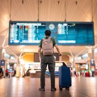male tourist looking at arrival and departure board at kuala lumpur international airport - travel stock pictures, royalty-free photos & images