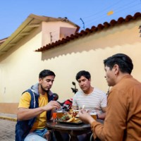 male traveler friends eating on outdoors restaurant in cusco, peru - junk food stock pictures, royalty-free photos & images