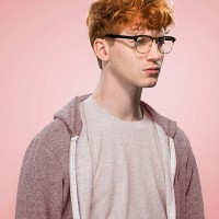 male with curly red hair and glasses looking away - fashion stock pictures, royalty-free photos & images