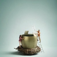 man and woman assembling golden egg in nest - home decoration stock pictures, royalty-free photos & images