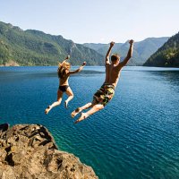 man and woman cliff jumping - travel stock pictures, royalty-free photos & images