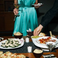 man and woman eating appetizers at cocktail party - food stock pictures, royalty-free photos & images
