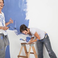 man and woman playing with paint - home decoration stock pictures, royalty-free photos & images