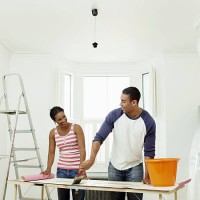 man and woman preparing to hang wallpaper - home decoration stock pictures, royalty-free photos & images