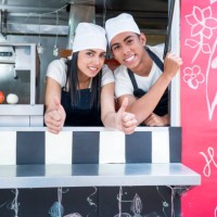 man and woman work at a food truck preparing fast food - junk food stock pictures, royalty-free photos & images