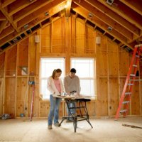 man and young woman looking at blueprints in house under construction - home decoration stock pictures, royalty-free photos & images