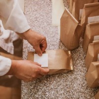 man applying label on paper bags in mill - food stock pictures, royalty-free photos & images
