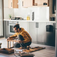 man assembling furniture at home. - home decoration stock pictures, royalty-free photos & images