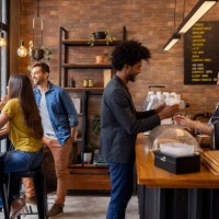 man at a cafe buying coffees to go - junk food stock pictures, royalty-free photos & images