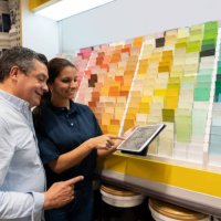 man at hardware store buying paint and talking to the saleswoman - home decoration stock pictures, royalty-free photos & images