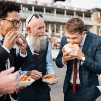 man biting into a burger - junk food stock pictures, royalty-free photos & images