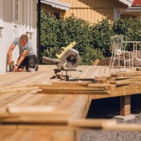 man building a wooden patio deck outdoors in his garden - home decoration stock pictures, royalty-free photos & images