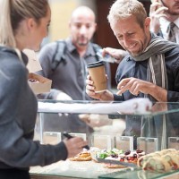 man buying food at city market - junk food stock pictures, royalty-free photos & images