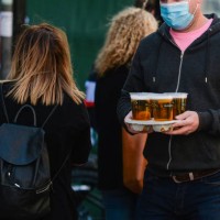Man carries takeaway pints in Dublin city center, during the COVID-19 lockdown. On Saturday, 17 April 2021, in Dublin, Ireland.