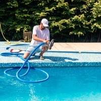 man cleaning the swimming pool - home decoration stock pictures, royalty-free photos & images