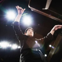 man conducting an orchestra at concert hall - concert stock pictures, royalty-free photos & images