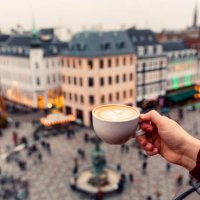 man drinking coffee with a view of copenhagen skyline, denmark - travel stock-fotos und bilder