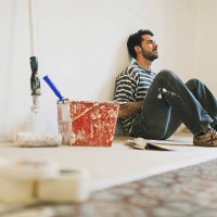man during a break while painting apartment. - home decoration stock pictures, royalty-free photos & images