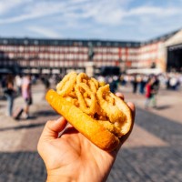 man eating bocadillo de calamares (calamari sandwich) on the street, personal perspective view - junk food stock pictures, royalty-free photos & images