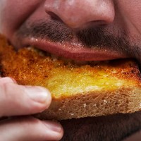 man eating bread - food fotografías e imágenes de stock