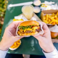 man eating cheeseburger, personal perspective view - junk food stock pictures, royalty-free photos & images