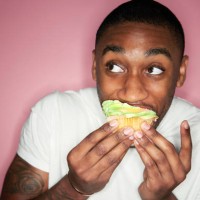 man eating cupcake - junk food stock-fotos und bilder