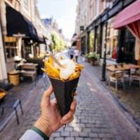 man eating french fries on the street, personal perspective - food stock pictures, royalty-free photos & images